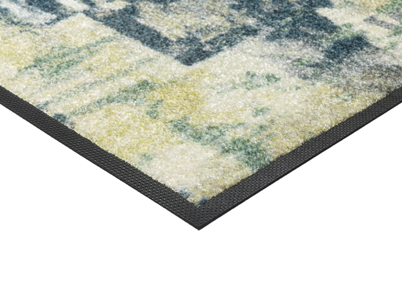 Eckansicht der Fußmatte mit blau, grünem abstraktem Muster