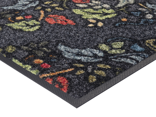 Eckansicht der Fußmatte in grau mit buntem floralen Ornamenten