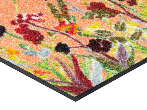 Eckansicht der Fußmatte in Rottönen mit farbenfrohen Blumen