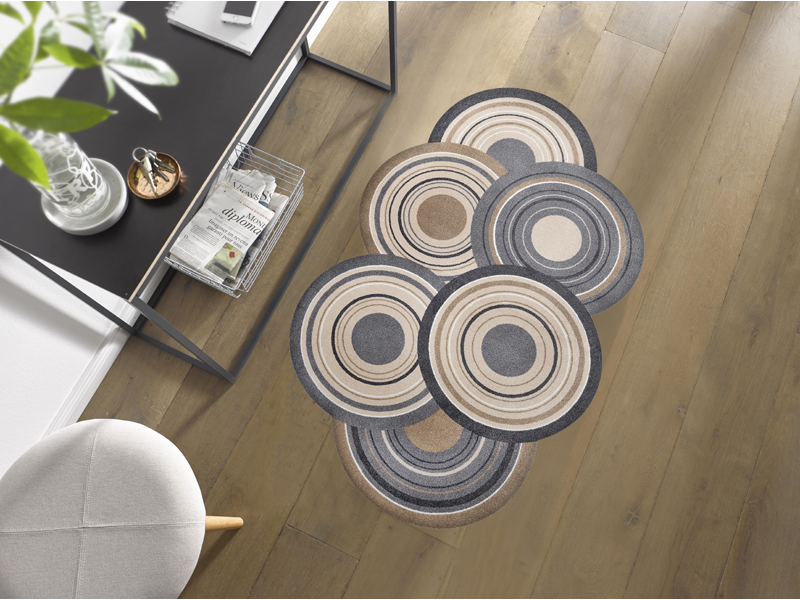 Fußmatte in Sonderform mit naturfarbenen Kreisen in der Garderobe
