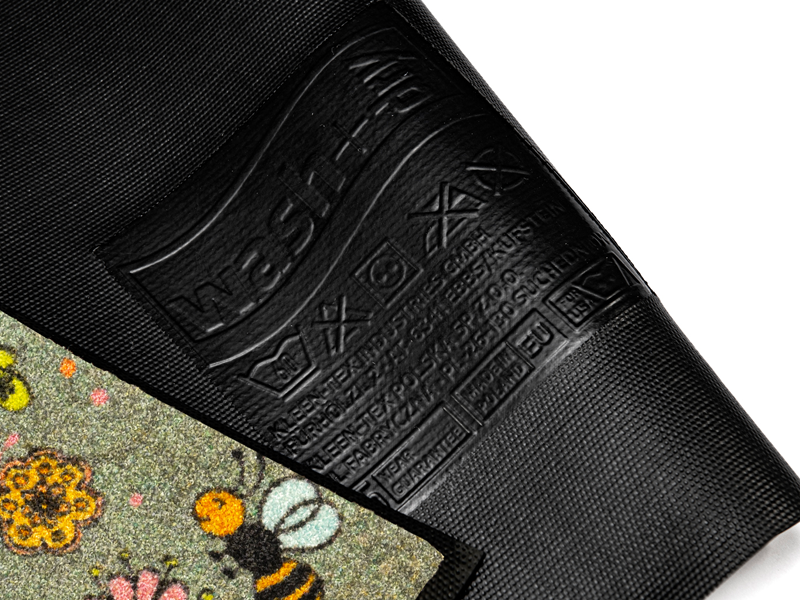 Rückenansicht der Fußmatte mit Blütenmotiven, Biene und Schriftzug "Home"