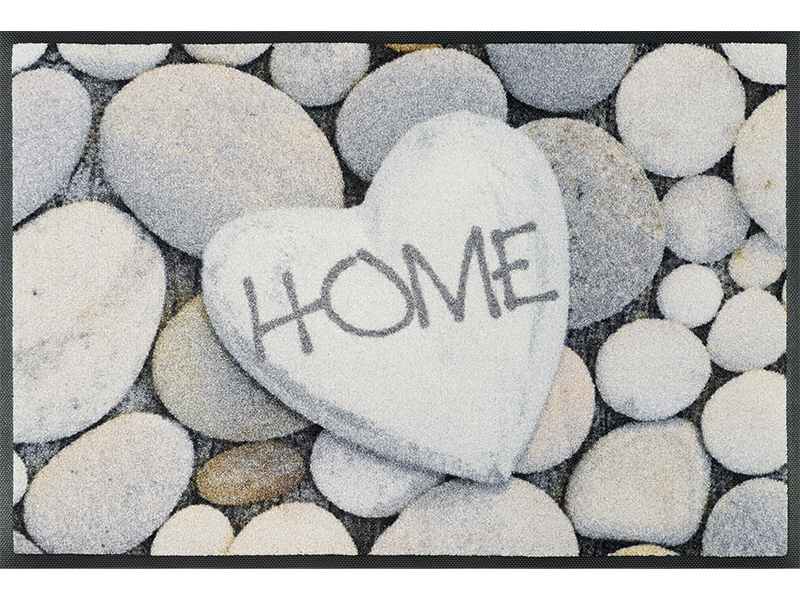 Fußmatte mit Steinen und Schrift "HOME"