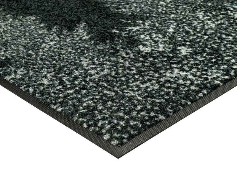 Eckansicht der Fußmatte mit grün-weißen Bäumen