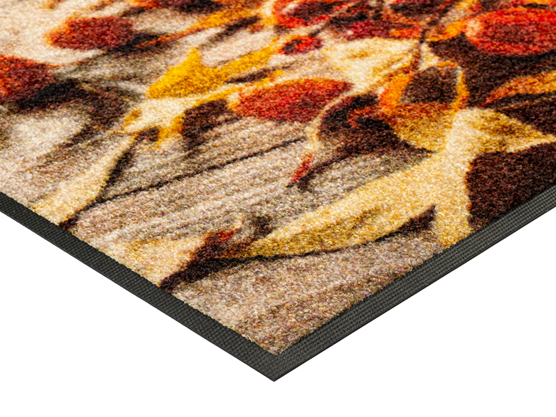 Eckansicht der Fußmatte mit herbstlichem Kürbismotiv