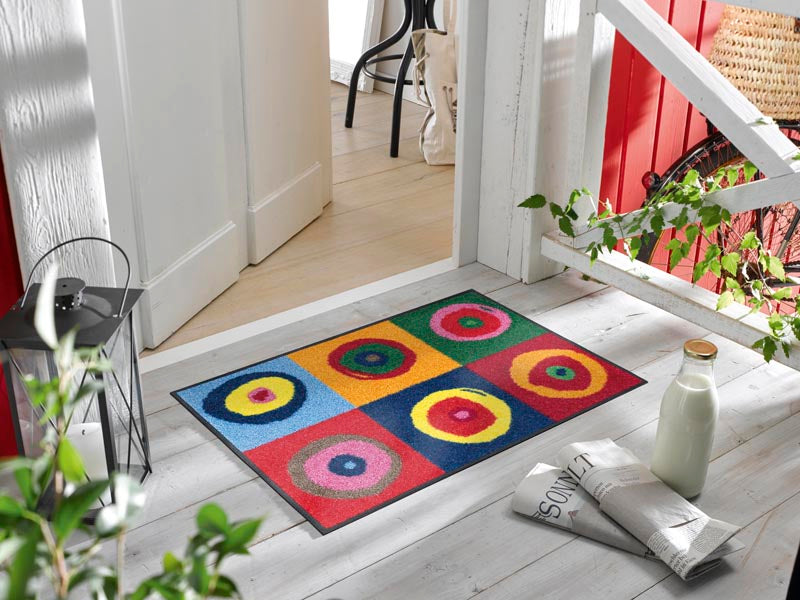 Fußmatte mit runden Kreisen in bunten Farben vor der Eingangstür