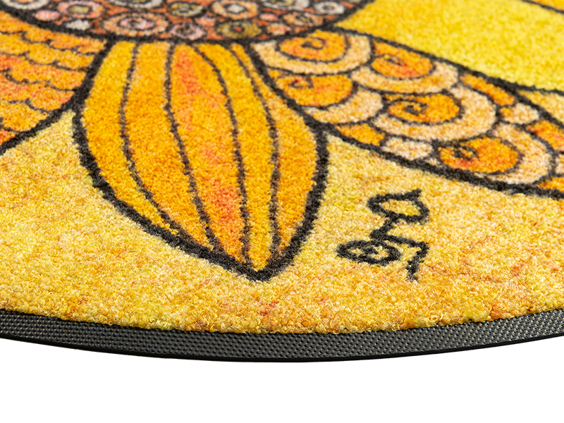 Eckansicht der runden Fußmatte mit gelbem Sonnenblumenmotiv