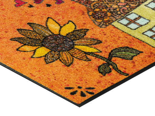 Eckansicht der Fußmatte mit gezeichnetem Haus und einer großen Sonnenblume