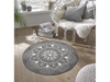 runde, graue Fußmatte mit weißem Sternen-Mandala im Wohnbereich
