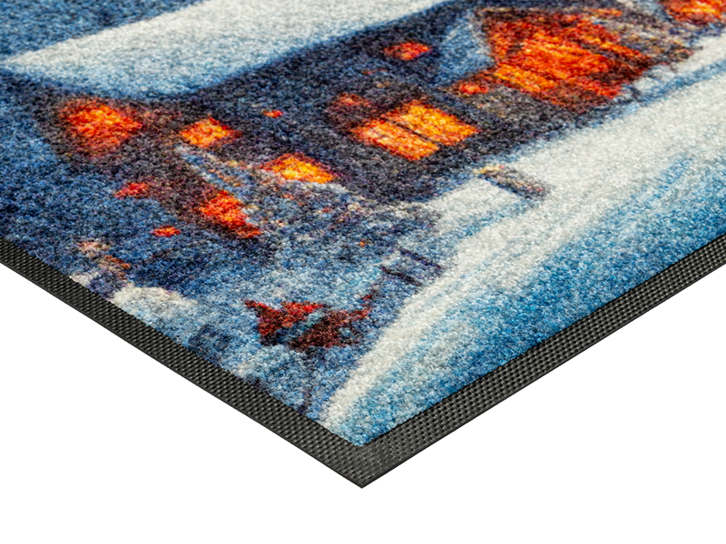 Eckansicht der Fußmatte mit winterlicher Landschaft und Häusern